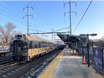 NJT Multilevel Cab Car # 7001 on the rear of NJT Train # 7818-note the passengers walking from the platform across the gondolas to board the eastbound train 